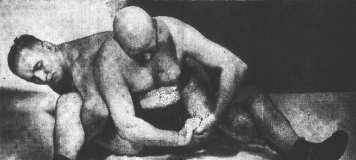 rudy-dusek-applying-hold-to-bald-wrestler